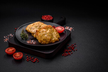 Delicious juicy fried chicken or pork pancakes with salt, spices and herbs