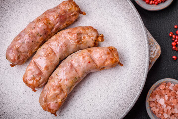 Delicious juicy grilled chicken or pork sausages with salt, spices and herbs
