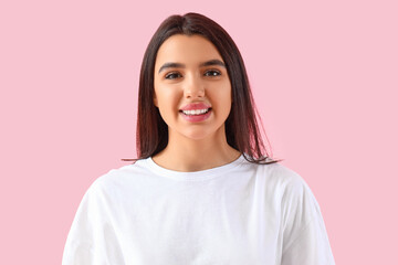 Smiling young woman with healthy teeth on pink background - obrazy, fototapety, plakaty