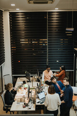 Business professionals collaborating in a bright office, analyzing reports and discussing strategies for business growth.