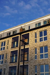 Fototapeta na wymiar Close up of new modern building in Noblessner district. Blue sky on the back. Tallinn, Estonia, Europe. January 2024.