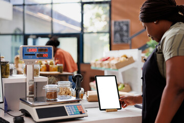 Advertisement with isolated white screen on tablet placed on counter promoting organic products....