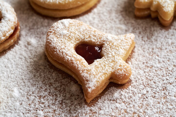 Bell shaped Linzer Christmas cookie filled with marmalade and dusted with sugar