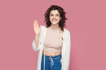 Portrait of smiling optimistic cheerful friendly attractive woman with curly hair wearing casual...