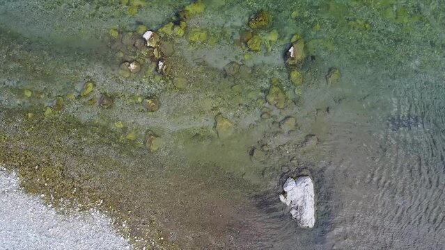 Drone footage of fisherman fly fishing in river in the mountains in summer. Mozirje, Slovenia