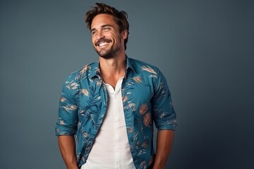 Portrait of a handsome young man laughing and looking at camera.