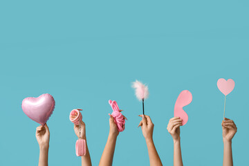 Many female hands with heart shaped balloon and sex toys on blue background. Valentine's Day celebration - obrazy, fototapety, plakaty
