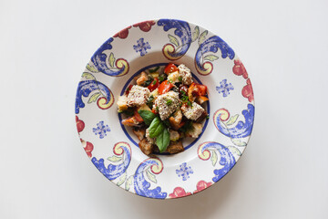Appetizing salad in a stylish retro plate. Food photo, mockup, menu.