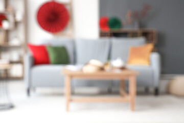 Blurred view of modern living room with sofa, table and decor for Chinese New Year celebration