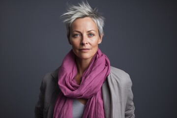 Portrait of a beautiful senior woman with grey hair and a pink scarf
