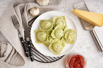 Plate of tasty ravioli on white background