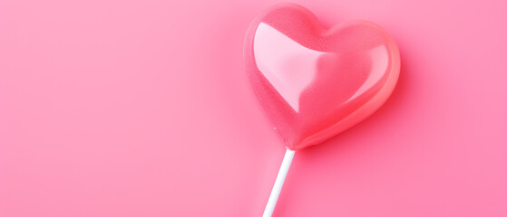 heart-shaped lollipop on a pink background on the day of love and friendship