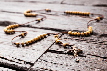 Catholic rosary holy necklace on wooden background