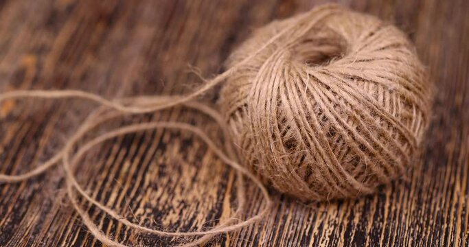 rough linen rope close-up, rough rope on a wooden table
