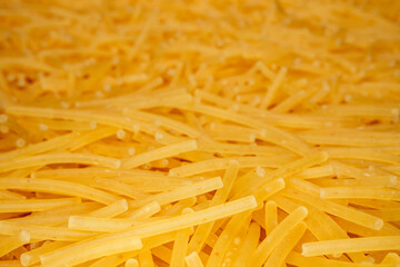 Close up of a pile of dry vermicelli pasta background. Pasta for soup