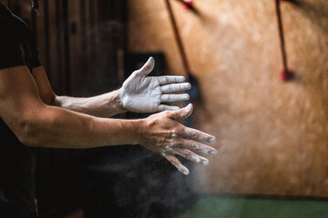 man in the gym with his hands in powder