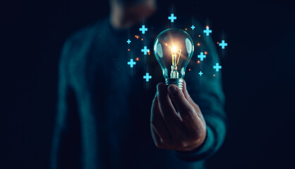Businessman hands holding illuminated lightbulb for idea concept, idea, innovation and inspiration,...