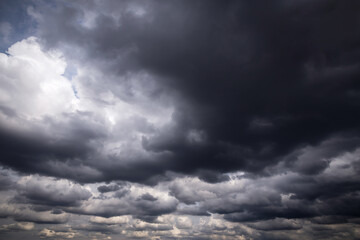 Epic Dramatic Storm sky with dark grey and black cumulus rainy clouds background texture,...