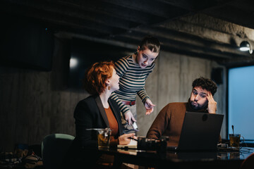 Dedicated business team working late at night in a corporate office to plan a project for profit growth and market expansion.