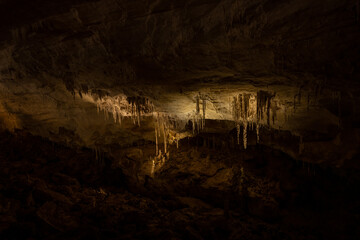 Stalactites LIt By Cave Lighting