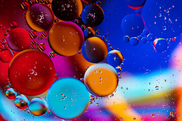 Colorful Oil Drops Bubbles and spheres. Flowing on Water Surface. Abstract background Macro Photography