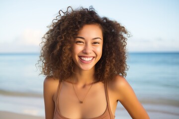 Bi-racial young woman smiling at beach