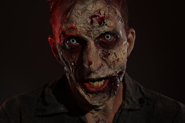 Scary zombie on dark background. Halloween monster