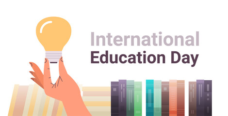 human hand holding light lamp near books new idea innovation international education day concept horizontal - Powered by Adobe