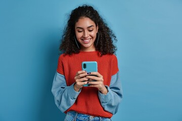 Young adult smiling happy pretty latin woman holding mobile phone device, doing ecommerce online shopping on cell, using apps on cellphone standing isolated on blue, Generative AI