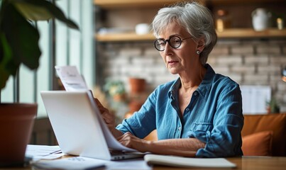 Adult senior 60s woman working at home at laptop. Serious middle aged woman at table holding document calculating bank loan payments, taxes, fees, retirement finances online with computer,GenerativeAI - obrazy, fototapety, plakaty