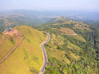 Transmission tower or pylon a steel lattice tower support overhead power line. Electricity transmission in mountain regions through complicated geographic conditions in karnataka, India.