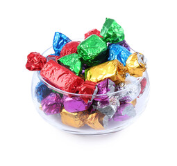 Bowl with many tasty candies in colorful wrappers on white background