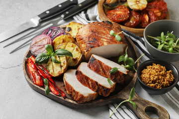 Delicious grilled meat and vegetables served on light grey table, closeup