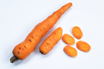 Carrots and sliced ​​carrot pieces isolated on white background.