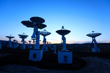 The silhouette of a radio telescope