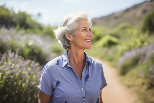 pretty senior woman in blue short sleeve blouse outdoors in sunshine