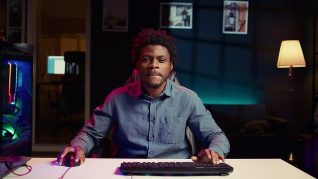 Excited gamer feeling happy after receiving winner screen on PC for killing all enemies and finishing level. Delighted player bragging after being victorious in gaming computer videogame