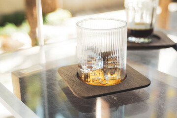 Glass with ice on table in coffee shop, stock photo