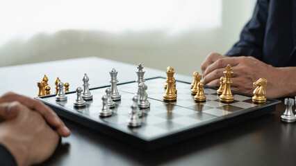 Close up of chess game with hands analyzing new strategy plan, teamwork concept, hands of...