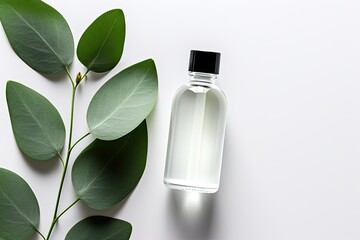 Top view of a white background showcasing a bottle containing hyaluronic acid and eucalyptus essential oil, accompanied by eucalyptus leaves.