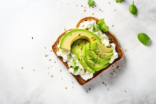 Healthy avocado open sandwich on white stone table