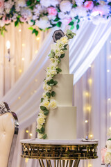 Beautiful white wedding cake decorated with flowers close up
