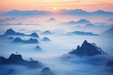 Morning fog reveals silhouettes of mountains