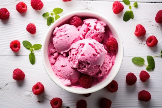 Overhead shot of raspberry ice cream in a white bowl