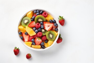 Top view of fresh fruit salad on white background