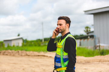 A Professional engineer or expert technician using radio communication or walkie-talkie to order...