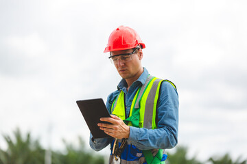 Professional engineer or technician inspector using tablet to working and checking to maintenance at solar panels farm system, Renewable energy and alternative sustainable innovation, sunlight power.
