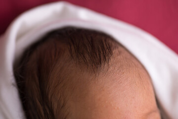 Top of newborn baby head with baby hair