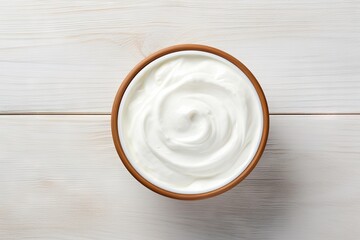 Greek yogurt in ceramic bowl on white wooden background top view copy space Fresh organic plain yogurt or sour cream