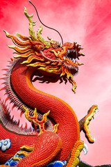 Red dragon statue with sky background